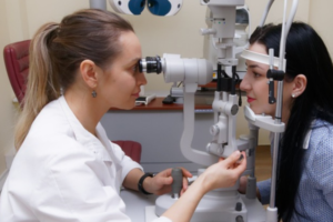 Image of optician carrying out eye test on a patient