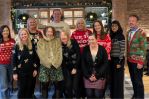 Image of PCB team wearing Christmas jumpers