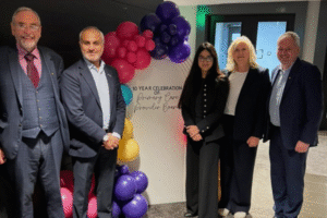 Image left to right of Stuart Allen, Dharmesh Patel, Luvit Kandula, Tracey Vell, Jim Rochford. All are stood against a background of balloons and a board saying ' celebrating 10 years of Pimary Care Provider Board